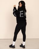 women oversized black sweatshirt side view