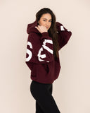 Women oversized burgundy hoodie side view