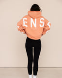 Women oversized orange hoodie back view