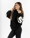 women oversized black hoodie side view